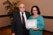 Dr. Nagib Callaos, General Chair, giving Prof. Nany Escobar the best paper award certificate of the session "Educación, Cibernética e Informática ." The title of the awarded paper is "La Lectura Digital como Estrategia para el Fomento de la Producción de Textos Académicos."